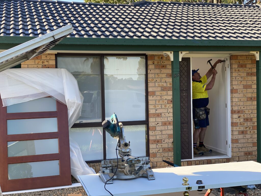 Doors Plus - Installer removing the old door